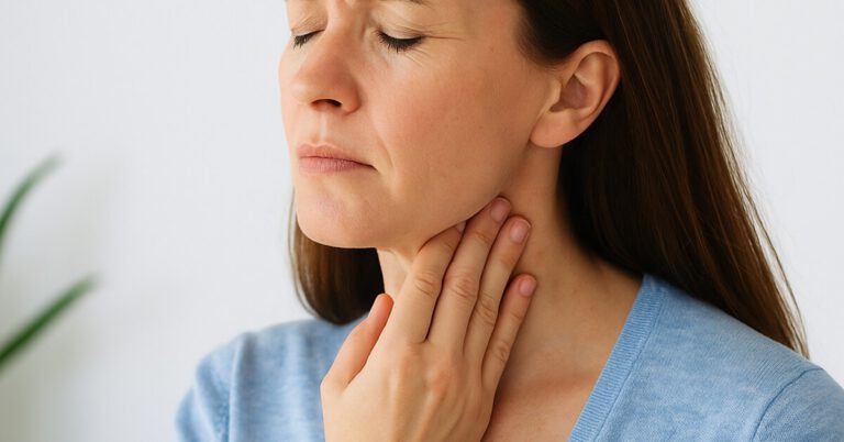 Woman touching neck as a sign of thyroid discomfort, representing thyroid symptoms and holistic health